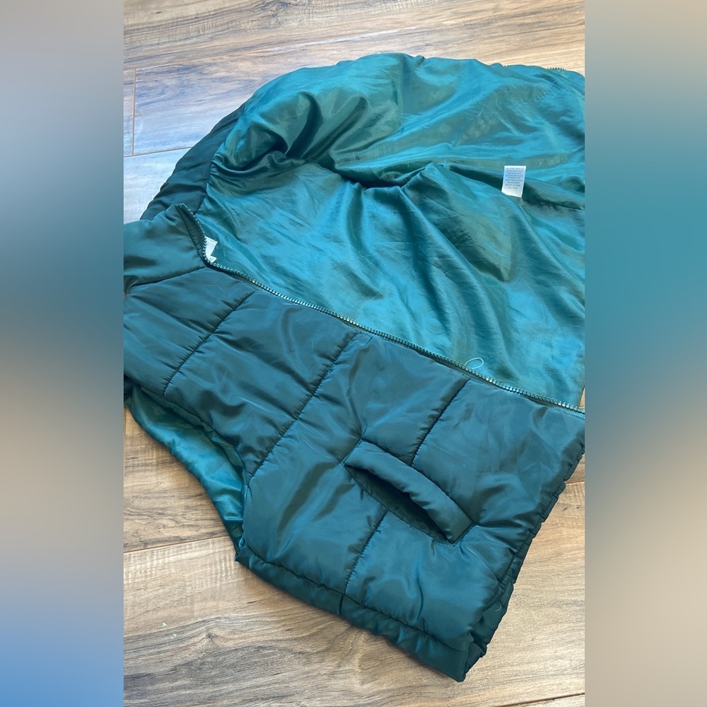 Dark green puffy vest. Super cute never worn sadly I took the tags off!